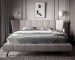 Thematic image about how to choose the right bed. Double bed in grey colors with a headboard.