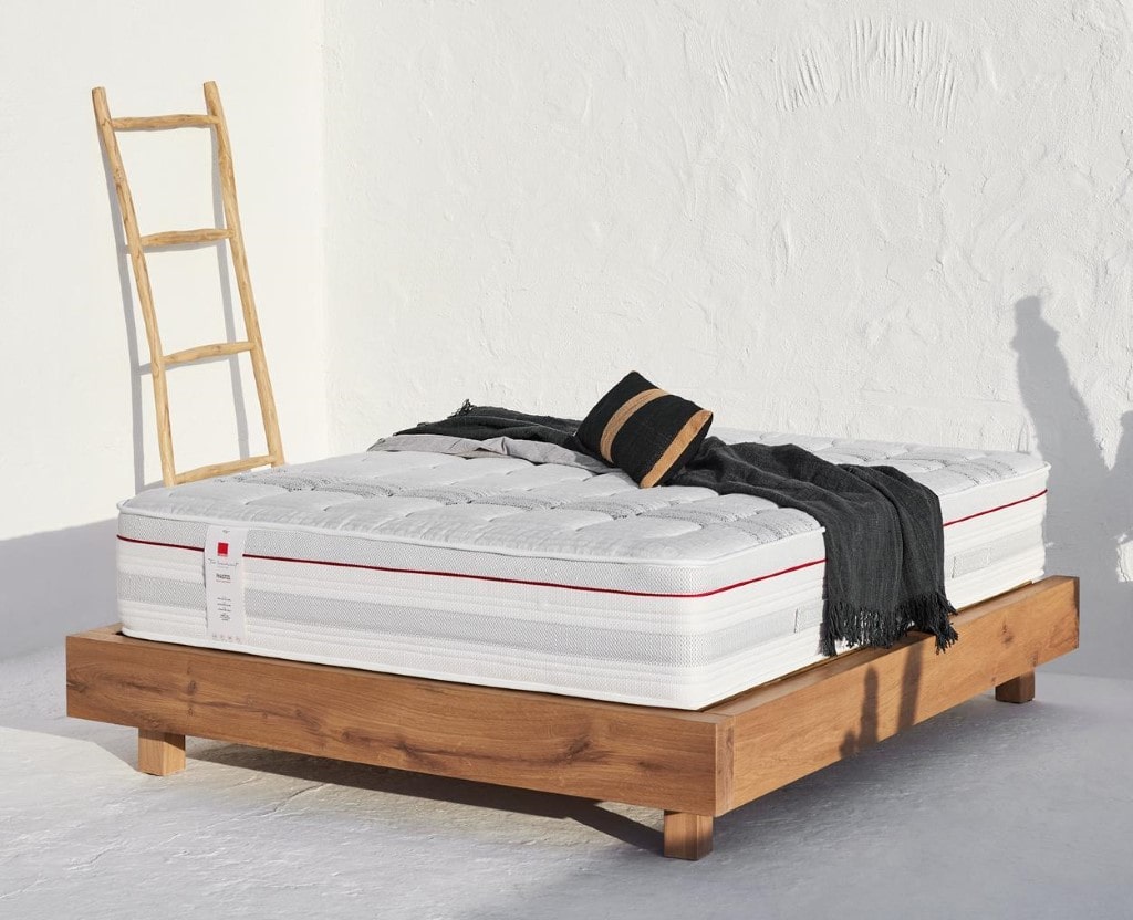 Good sleeping Phaistos mattress lying outdoors, on a wooden bed frame.