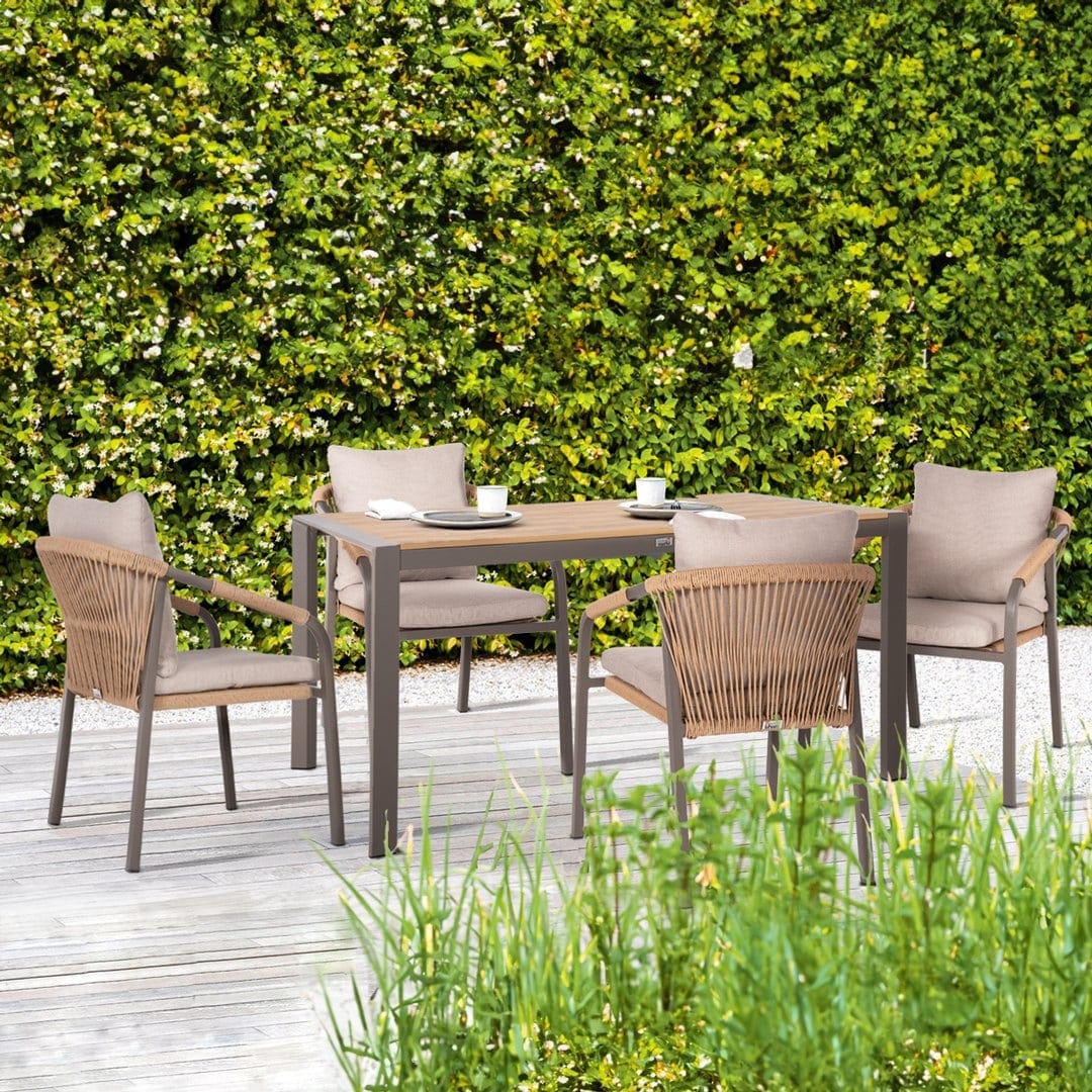 Garden dining table with rattan chairs and table made of wood and metal.